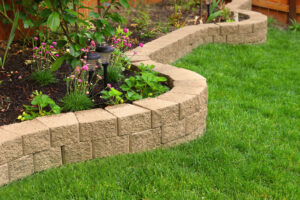 manufactured stone used as landscape edging in a backyard